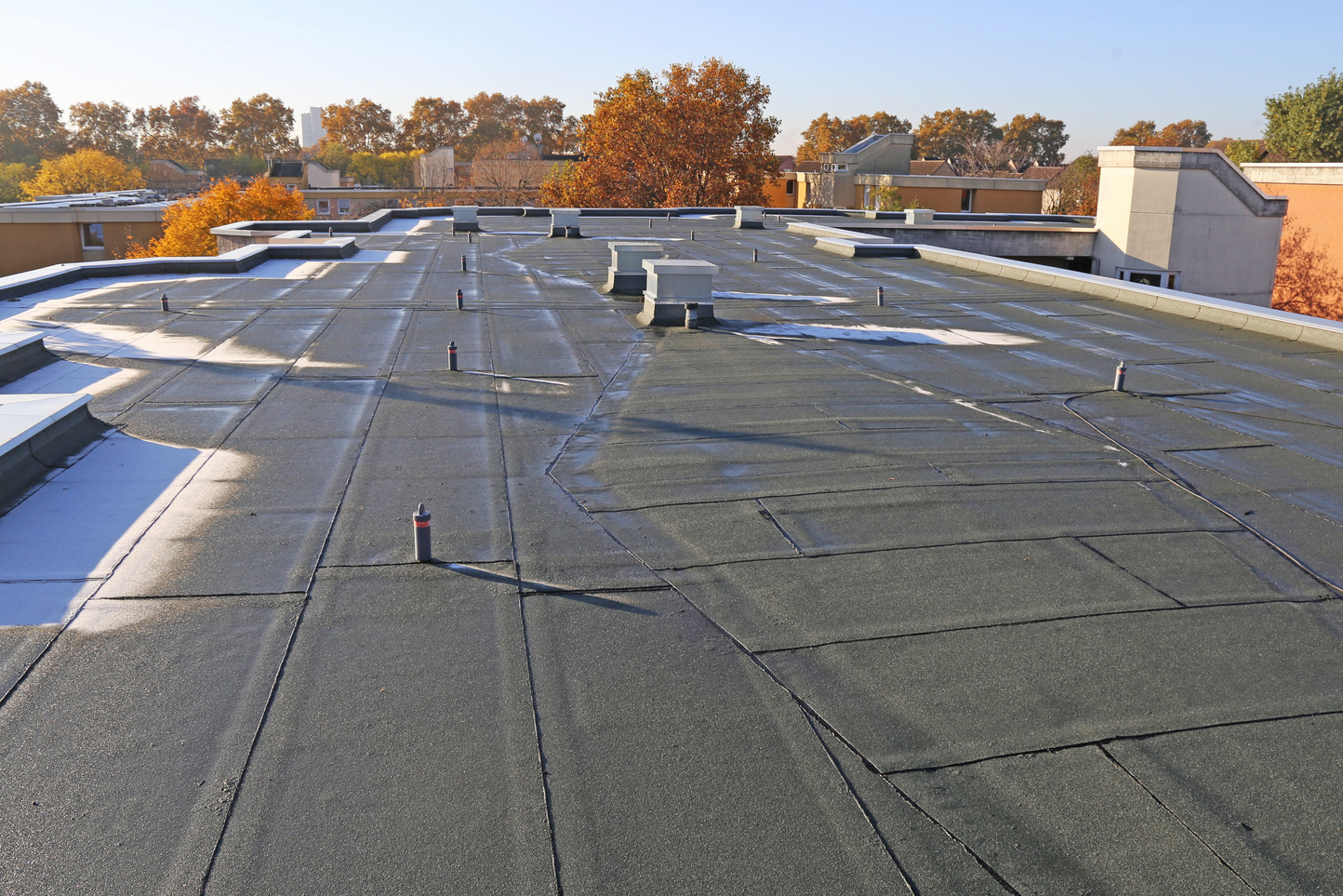 Building with newly renovated flat roof sealing